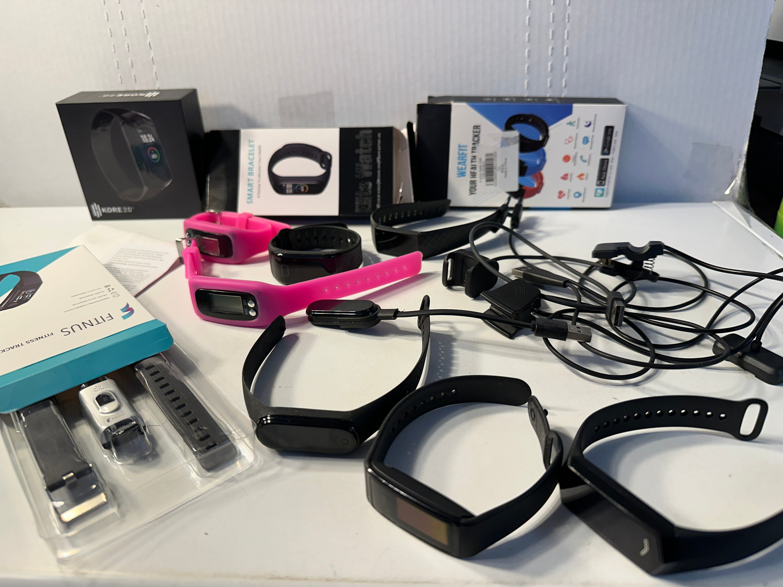 Fitness Tracker Watch Lot of 9 – With some chargers and some boxes.